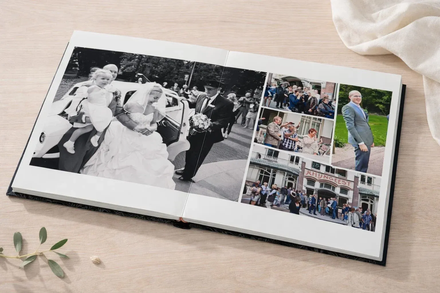 Opengeslagen album met een zwart-witfoto van het bruidspaar dat uit de auto stapt, omringd door gasten