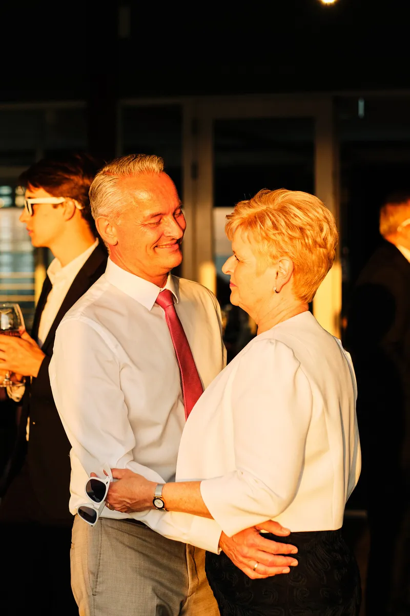 Een oudere gast danst lachend