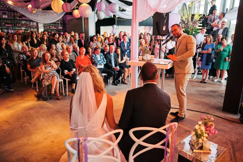 De ceremonie in The Boathouse: het bruidspaar zit vooraan, de gasten kijken toe