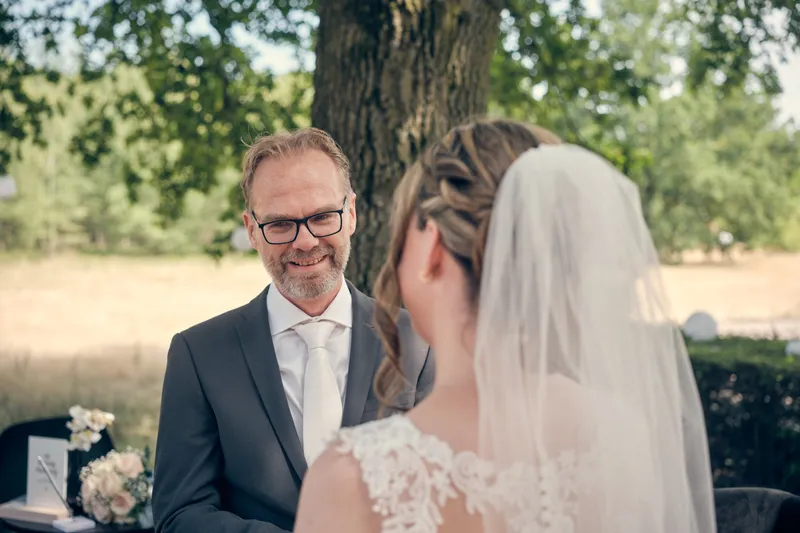 Ilja en Mike kijken elkaar aan onder de boom tijdens de ceremonie