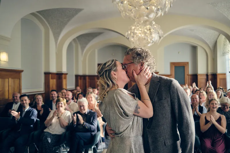 Jiska en Gerrit kussen elkaar, de gasten klappen