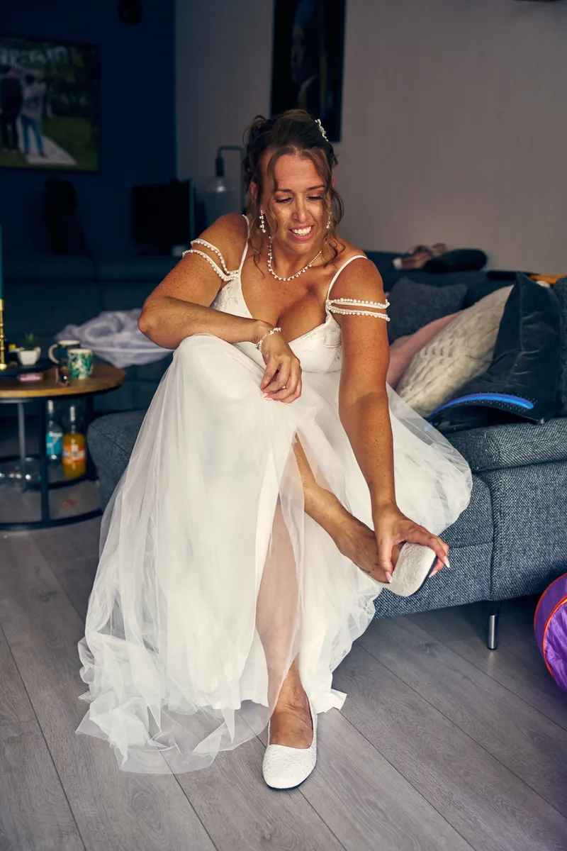 Diliana trekt lachend haar schoenen aan in de woonkamer