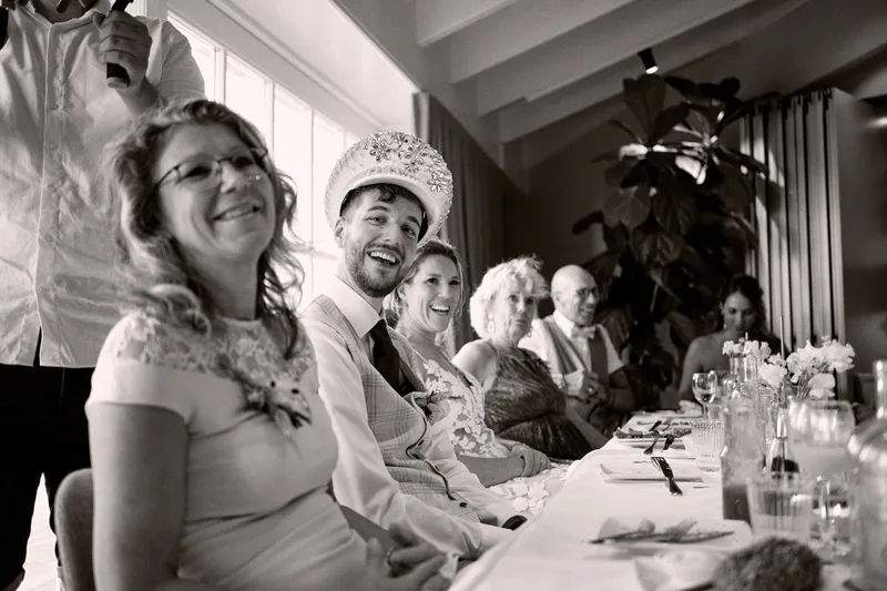 Gasten lachen aan tafel tijdens het diner