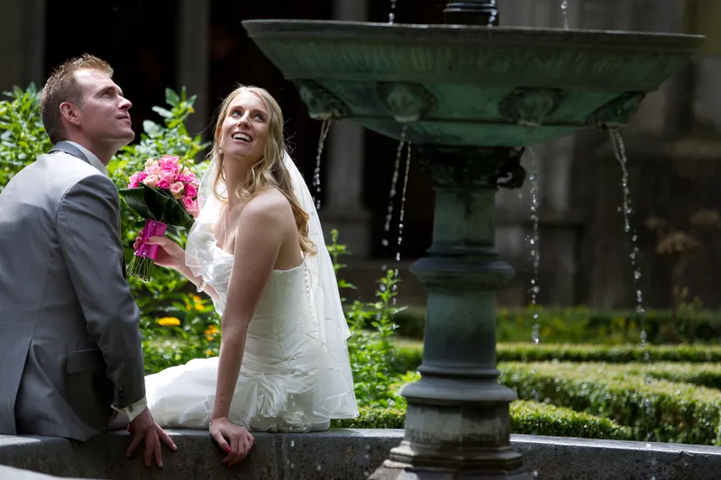 Jan en Loes kijken omhoog bij de bronzen fontein in de tuin naast de Domkerk