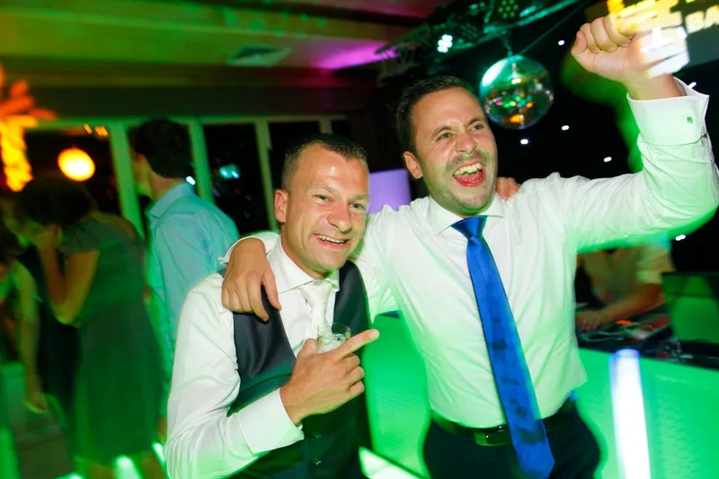 Nick en een vriend op de dansvloer in groen licht