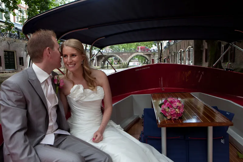 Jan kust Loes op de wang in een aangemeerd bootje aan de gracht