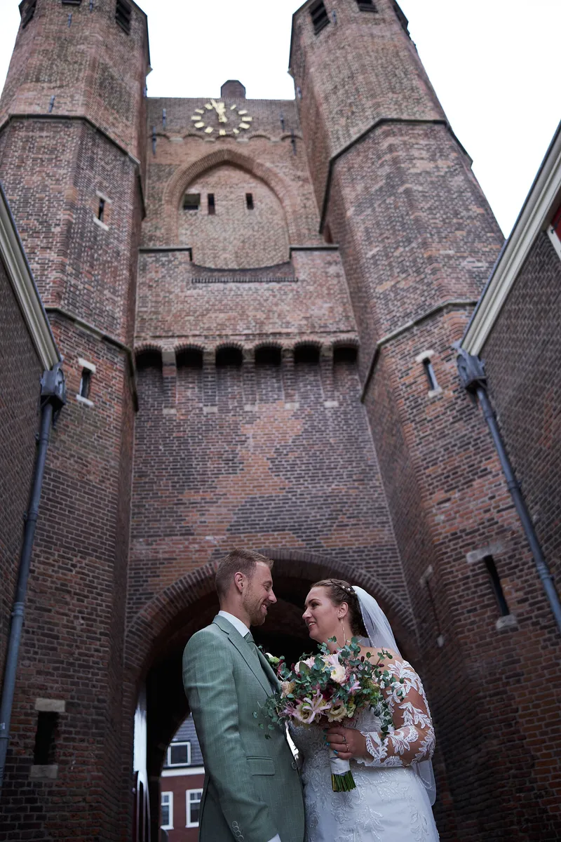 Liëla en Jeffrey onder de boog van de Amsterdamse Poort