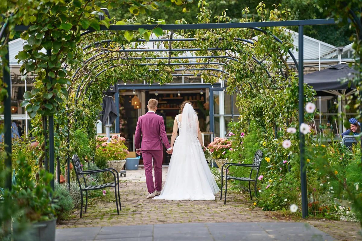 Emmely en Tom onder de begroeide pergola van Villa Ockenburg