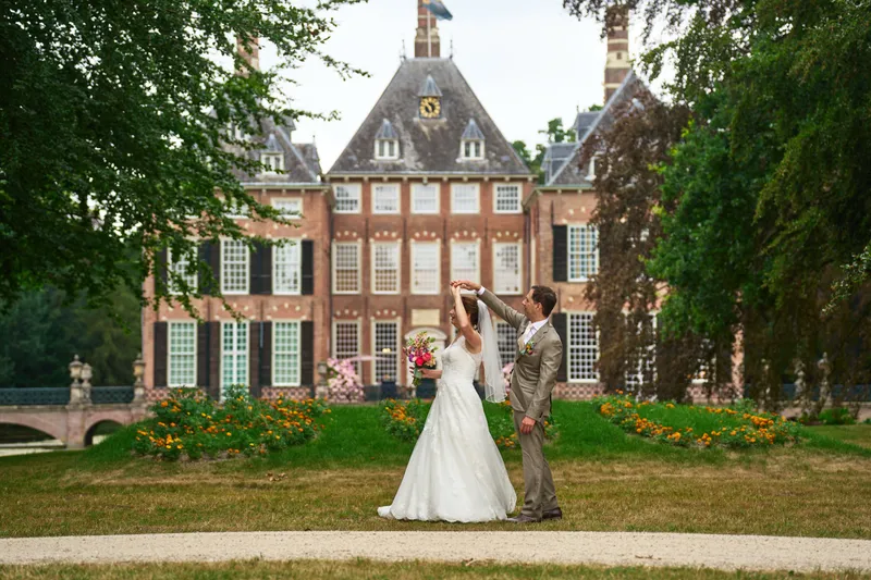 Rutger laat Caroline ronddraaien op het gras voor Kasteel Duivenvoorde