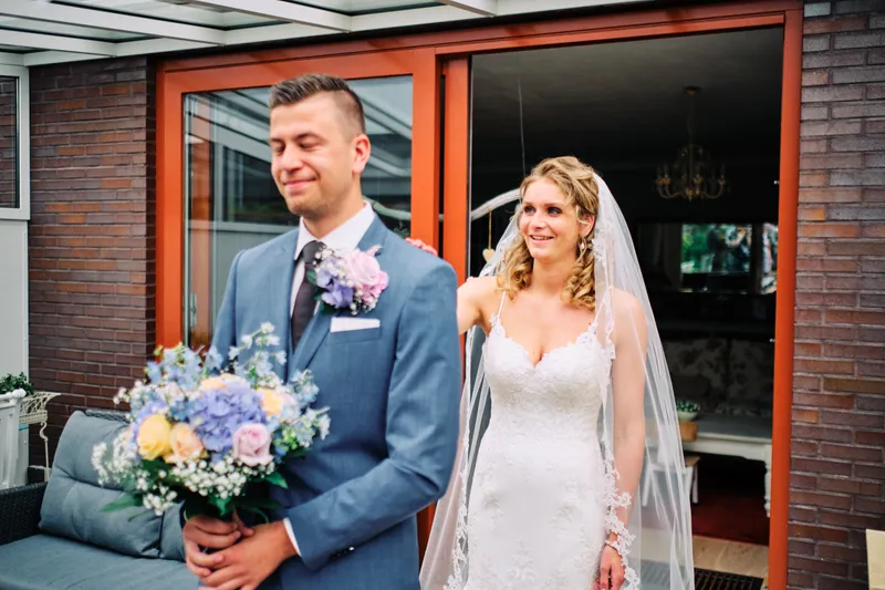 Lotte en Daniel bij een glazen deur voor een bakstenen huis