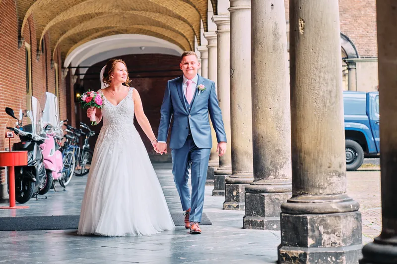 Victoria en Stefan lopen door een zuilengang bij de Tweede Kamer