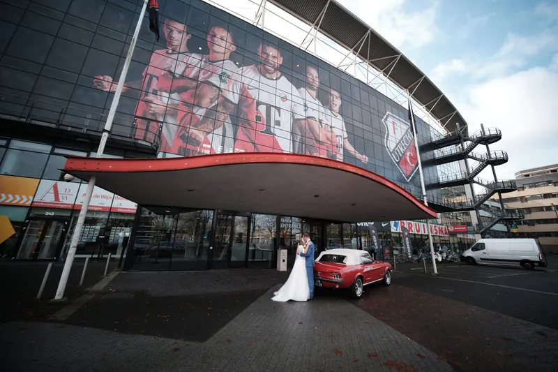 Wendy en Gerrold met de rode Mustang voor het stadion