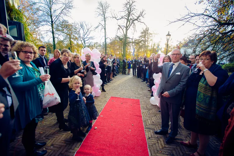 De gasten staan langs de rode loper