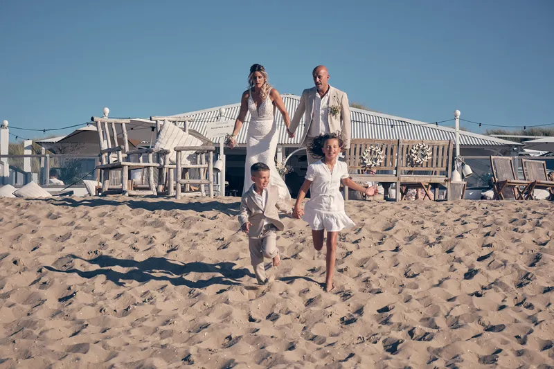Het gezin rent over het strand