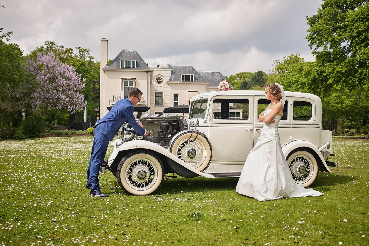 Femke en Arjan bij de oldtimer op het gazon van Te Werve