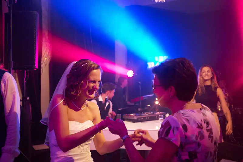 Femke danst met een gast in blauw licht