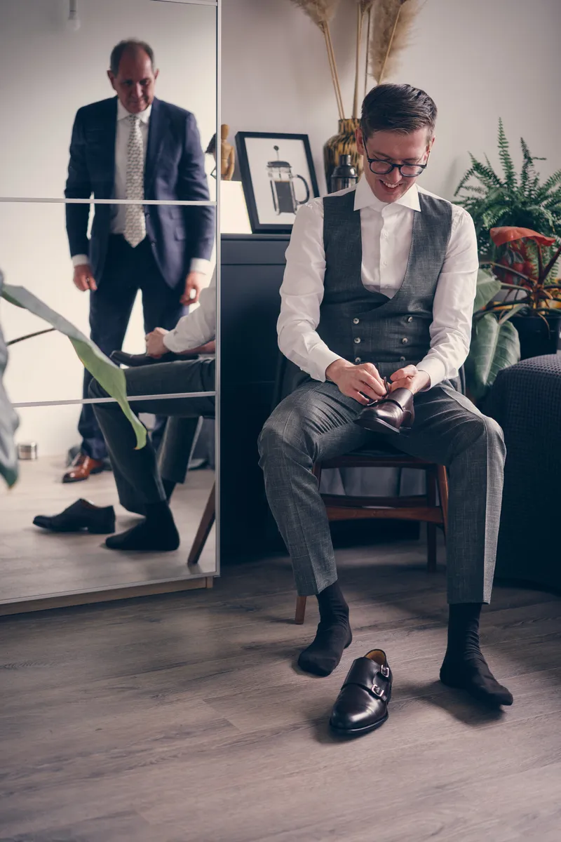 Yvo trekt zijn schoenen aan, met zijn vest al aan