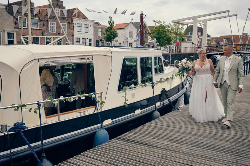 Marco en Tamara lopen over de steiger naar de boot in Brielle
