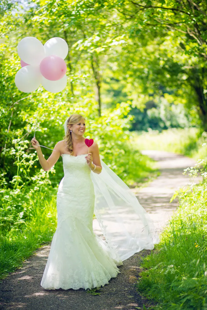 Nienke met ballonnen op het bospad