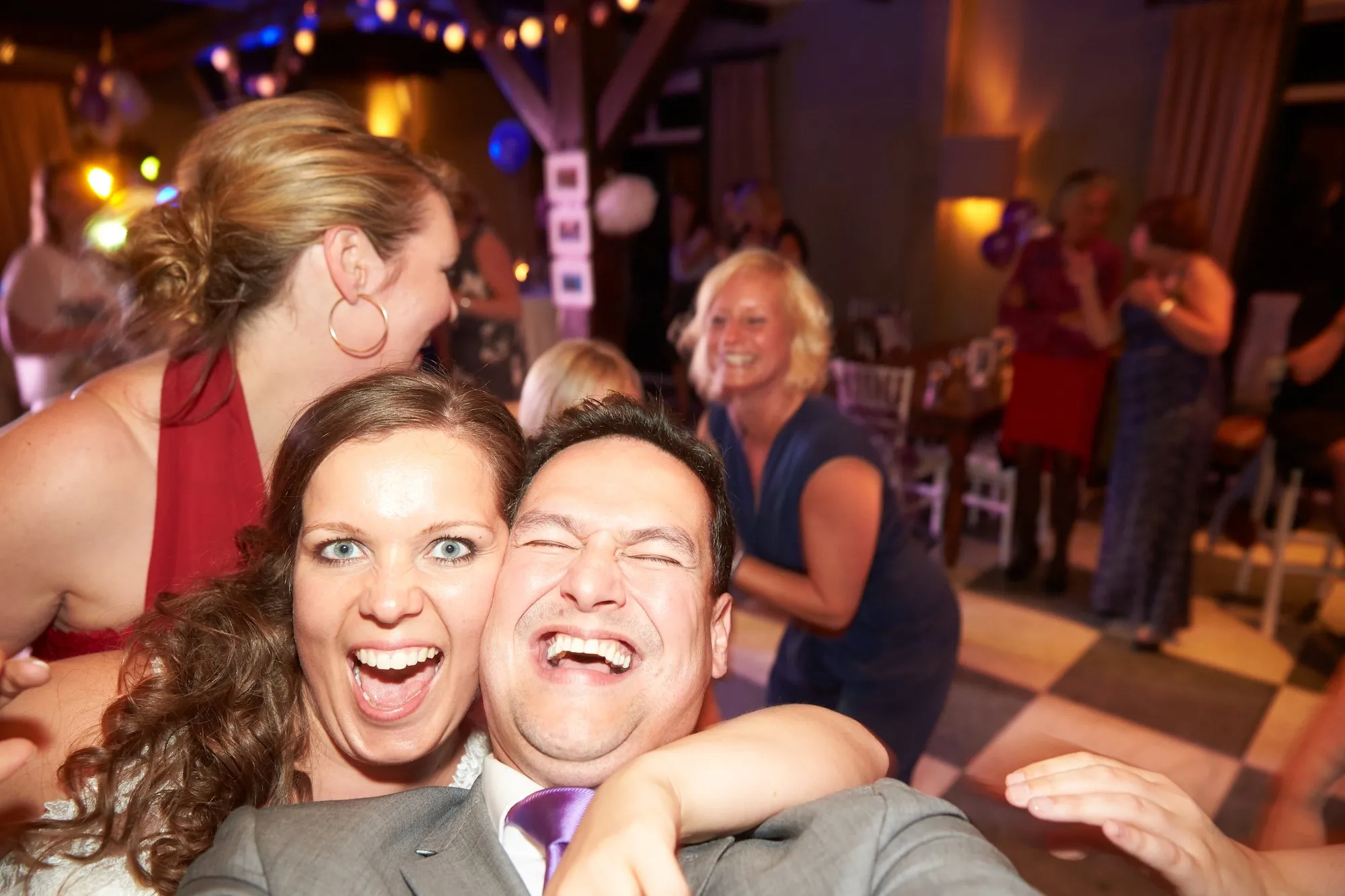 Stefan maakt een selfie met het bruidspaar en gasten op het feest